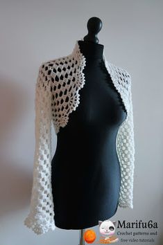 a black mannequin with a white crochet shawl on it