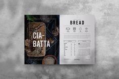 the bread cookbook is open on a gray surface with an image of bread and spices