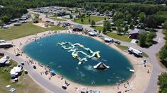 an aerial view of a lake with inflatable water slides