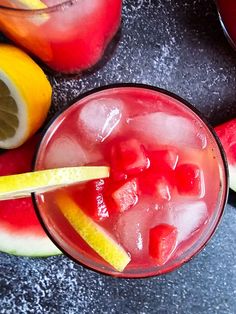 two glasses filled with watermelon and lemonade next to some sliced up fruit