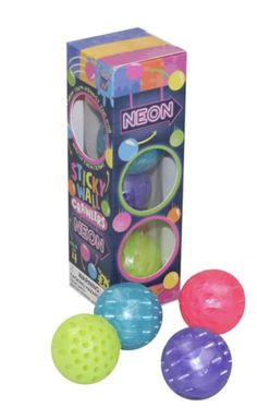 three colorful balls are in front of a box