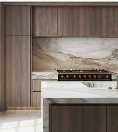 a kitchen with marble counter tops and wooden cabinetry, along with an oven in the center