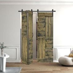 two wooden doors are open in a white room with wood flooring and wall decor