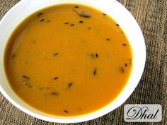 a white bowl filled with soup on top of a table