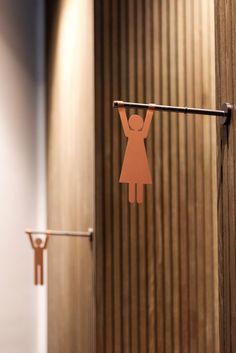 a paper cut out of a woman hangs on a clothes line in front of a door