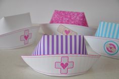 three paper bowls with designs on them sitting next to each other and one has a pink heart in the center