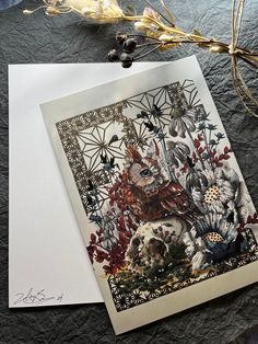 a card with an image of birds and flowers on it next to some dried plants