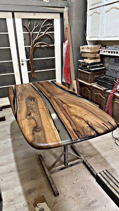 the table is made out of wood and has been finished with black walnut veneers