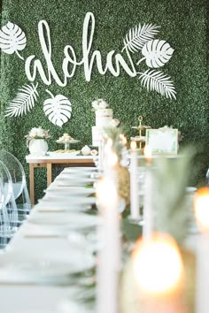 the table is set with white plates and candles