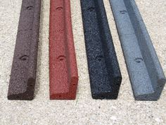 four different colored brick laying next to each other on top of a cement flooring