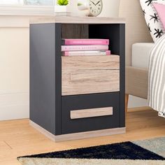 a nightstand with drawers and a clock on the wall