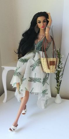 a doll is holding a purse in her hand