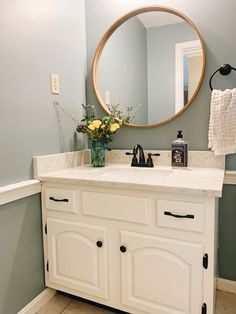 a bathroom with a sink and mirror in it