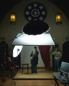 a man standing in front of a camera on top of a wooden floor