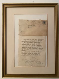 an old piece of paper with writing on it in a gold frame hanging on the wall