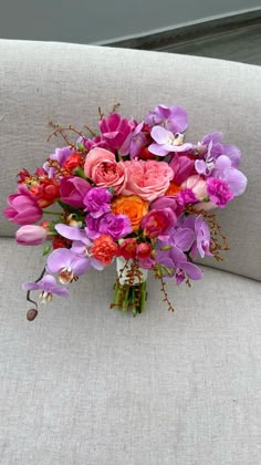 a bouquet of flowers sitting on top of a couch