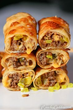 cheeseburger egg rolls are stacked on top of each other