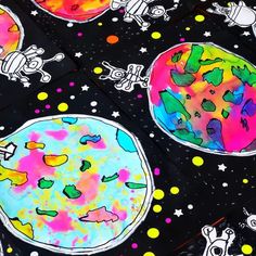 the outer planets are painted on black paper with colorful dots and stars around them, as if they were floating in space