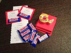 some candy bars are sitting on a table next to a pair of tape measures