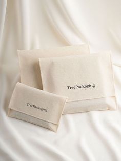 two pieces of cloth with the words tree packaging printed on them