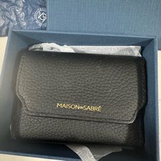 a black leather case in a box with the name maison - sabre on it