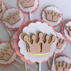 pink and gold cupcake toppers on sticks with crown cutouts in the middle