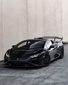 a black sports car parked in front of a building