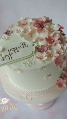 a white cake with pink flowers on it