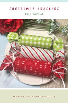 three wrapped presents on a plate next to flowers