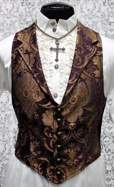 Note: These vests are very fitted. Check the size measurements below very carefully to find the size that will fit you best. A Victorian gentleman's vest with class. Great for formal occasions, can be worn under a suit jacket or by itself. Made in rich purple and gold tapestry fabric with black satin lining and back. This vest has a very flattering tapered fit and ties in back with satin belting so it can be made tighter in the waist. Fastens in front with six metal buttons. A notched collar add Aristocrat Vest, Mode Steampunk, Steampunk Men, Gold Tapestry, Style Steampunk, Steampunk Wedding, Steampunk Clothing, Dieselpunk, Steampunk Fashion