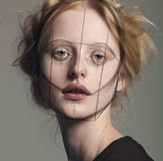 a woman's face is seen through a wire fence, with the image of a person behind it