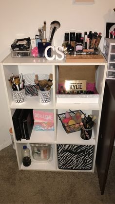 a white shelf filled with lots of makeup and personal care items on top of it