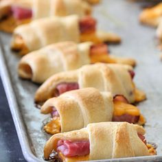 several pastries are lined up on a baking sheet