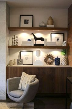 a living room filled with lots of furniture and pictures on the wall above it's shelves