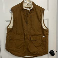 Lee Workwear Canvas Vest, Sherpa Lined For Warmth. Size Large. 3 Outer Pockets, One Inner Pocket Winter Cotton Vest With Multiple Pockets, Outdoor Work Vest With Pockets For Fall, Brown Outerwear With Pockets For Outdoor Work, Brown Utility Vest For Fall, Utility Vest For Outdoor Work In Fall, Fall Utility Vest For Outdoor Work, Casual Vest For Outdoor Work In Fall, Winter Utility Vest For Outdoor Work, Workwear Vest