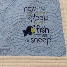 a quilted wall hanging with the words now i lay me down to sleep i count fish instead of sheep