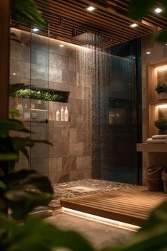 a bathroom with a shower, sink and plants in the shower headlight is on