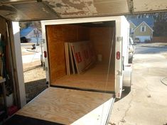 the inside of a storage trailer with its doors open and books in it's back