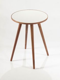 a round table with wooden legs and a white top on an isolated surface, viewed from the side