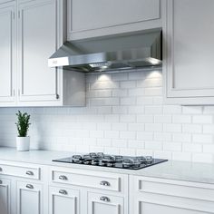 a stove top oven sitting inside of a kitchen next to white cabinets and counter tops