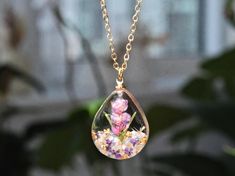 This necklace features Gladiolus, the birth flower for August, carefully preserved in a clear resin pendant. Gladiolus is symbolic of strength of character, faithfulness, moral integrity, and remembrance, making this necklace a perfect personalized birthday gift. Material: 14k gold filled chain and components or Silver, Resin Flower: Real Pressed Flower Chain Length: 18" (45cm)  Pendant Width: 0.79" (2cm) Pendant Height: 0.98" (2.5cm) Every pieces is made by hand and unique, therefore each piece Spiritual Birth Flower Pendant Charm Necklace, Spiritual Birth Flower Pendant Necklace, Spiritual Pendant Jewelry With Pressed Flowers, Spiritual Flower Necklace Gift, Spiritual Flower Pendant Necklace Gift, Spiritual Flower Necklace For Gifts, Spiritual Flower Necklace For Gift, Spiritual Necklaces With Pressed Flowers As Gift, Spiritual Style Necklace With Pressed Flowers As A Gift