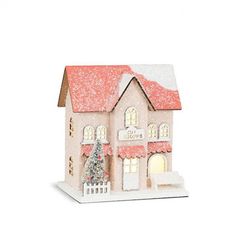 a small doll house with a christmas tree in the front