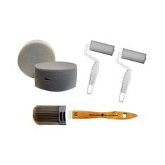 the paintbrush is next to two brushes and some other items on a white background