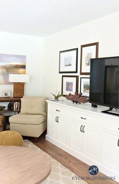 a living room filled with furniture and a flat screen tv on top of a wooden table