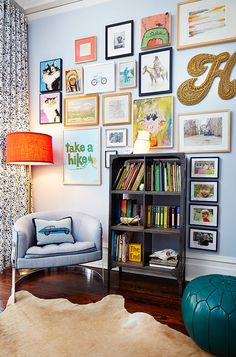 a living room filled with furniture and lots of pictures on the wall above it's bookshelf