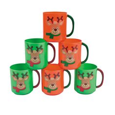 six green and orange coffee mugs with reindeer faces on them, all decorated in different colors