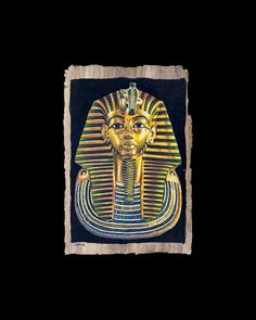 an egyptian mask with gold and blue colors