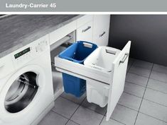 a washer and dryer in a room with tile flooring, white cabinets and gray counter tops