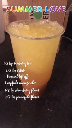 a glass filled with orange juice sitting on top of a table