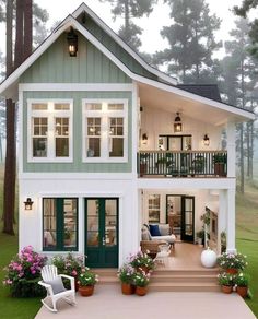 a house with green shutters and white trim on the front porch, covered in potted plants